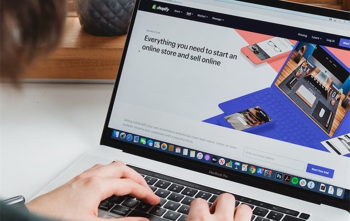Man viewing shopify homepage