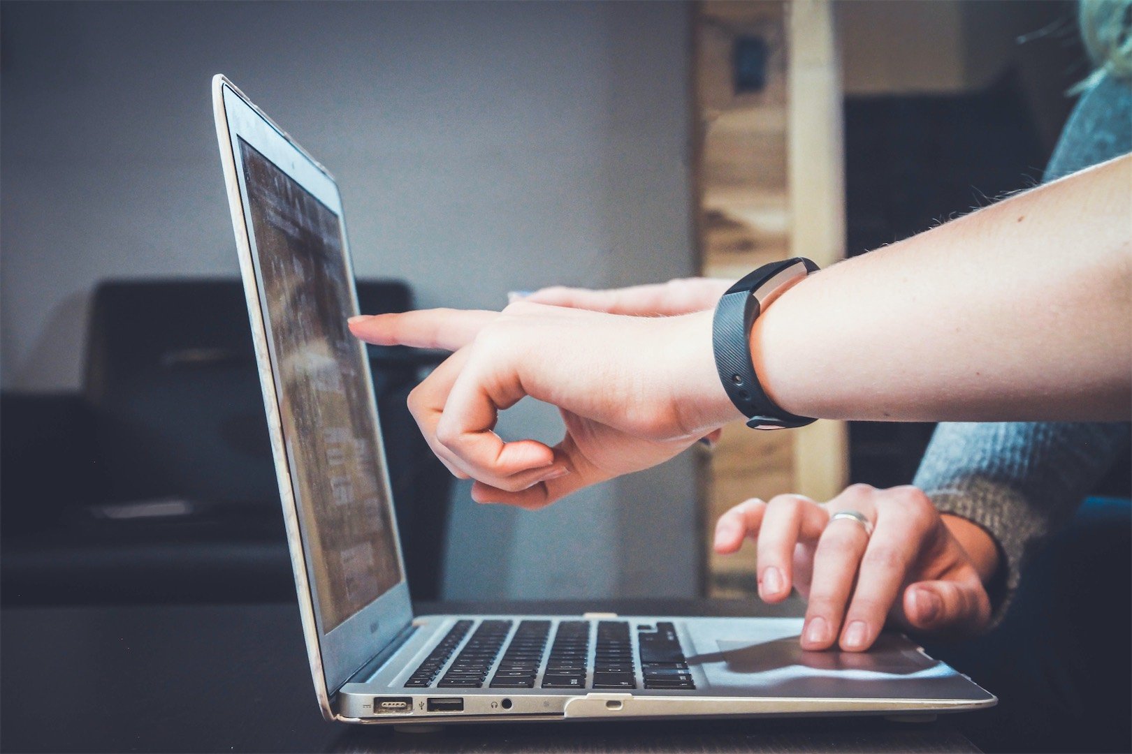 People pointing to a screen trying to navigate a website