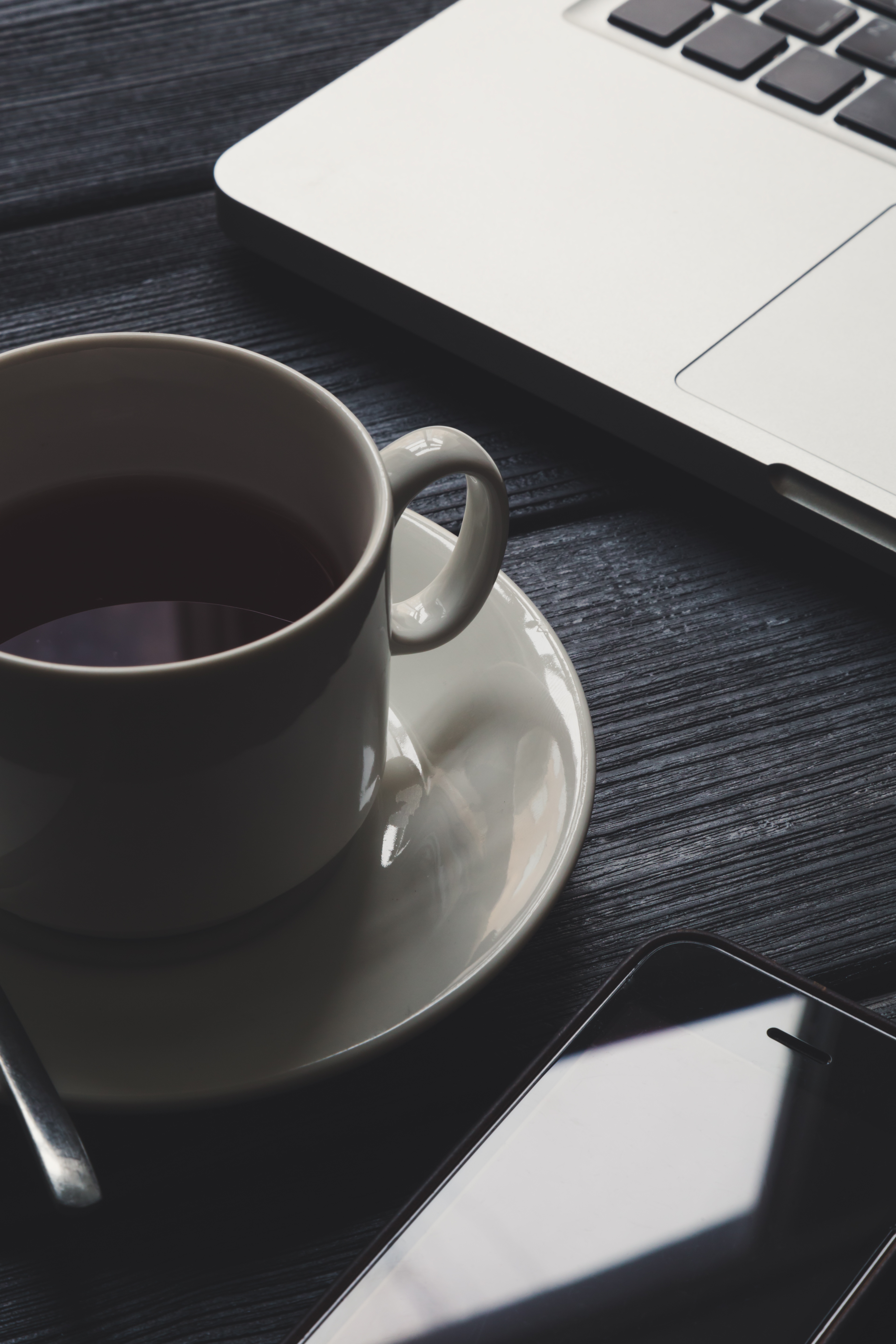 office-table-with-notepad-computer-and-tea-cup-P267VMQ